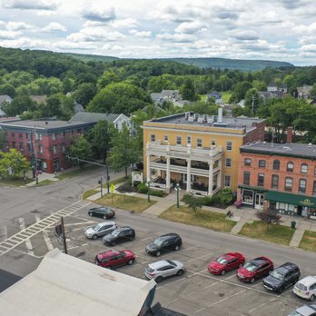 Drone shot showing hotel corner lot position at intersection with downtown context