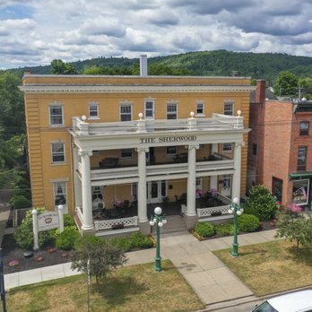 Straight-on elevated drone shot of the full facade with THE SHERWOOD lettering