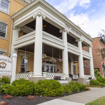 Street-level close-up of front porch and columns with THE SHERWOOD text