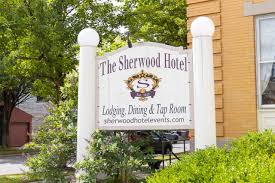 Hotel sign with building partially visible behind