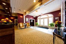 View from front desk toward arched entrance doors with burgundy walls