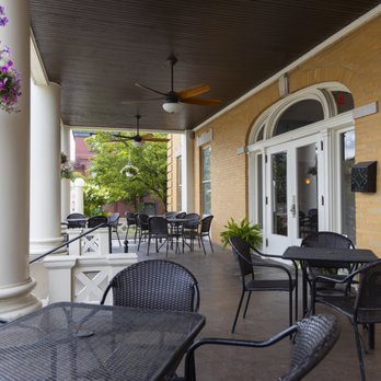 Closer angle of porch seating with arched French doors