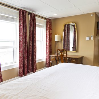 King room from a different angle showing desk and vanity area with mirror, window, and bed
