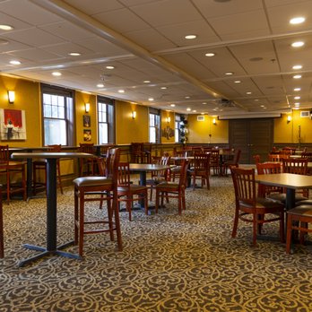 Tap Room dining setup with bistro tables and yellow walls