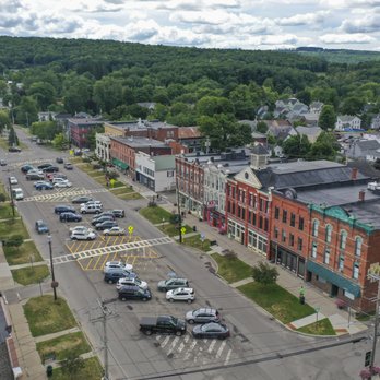 Drone shot of downtown Greene with historic storefronts and hills