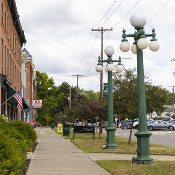 Street-level shot with globe lampposts and adjacent storefronts