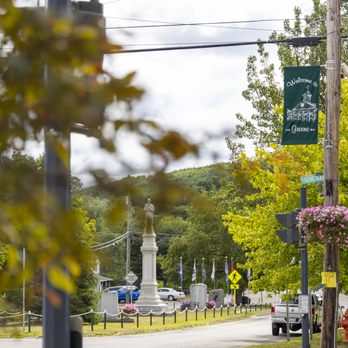 Welcome to Greene banner with memorial monument and fall foliage